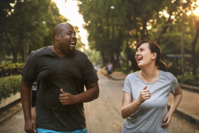 image of two people running and smiling